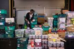 A worker sorts through supplies at a food bank&nbsp;in Camden.