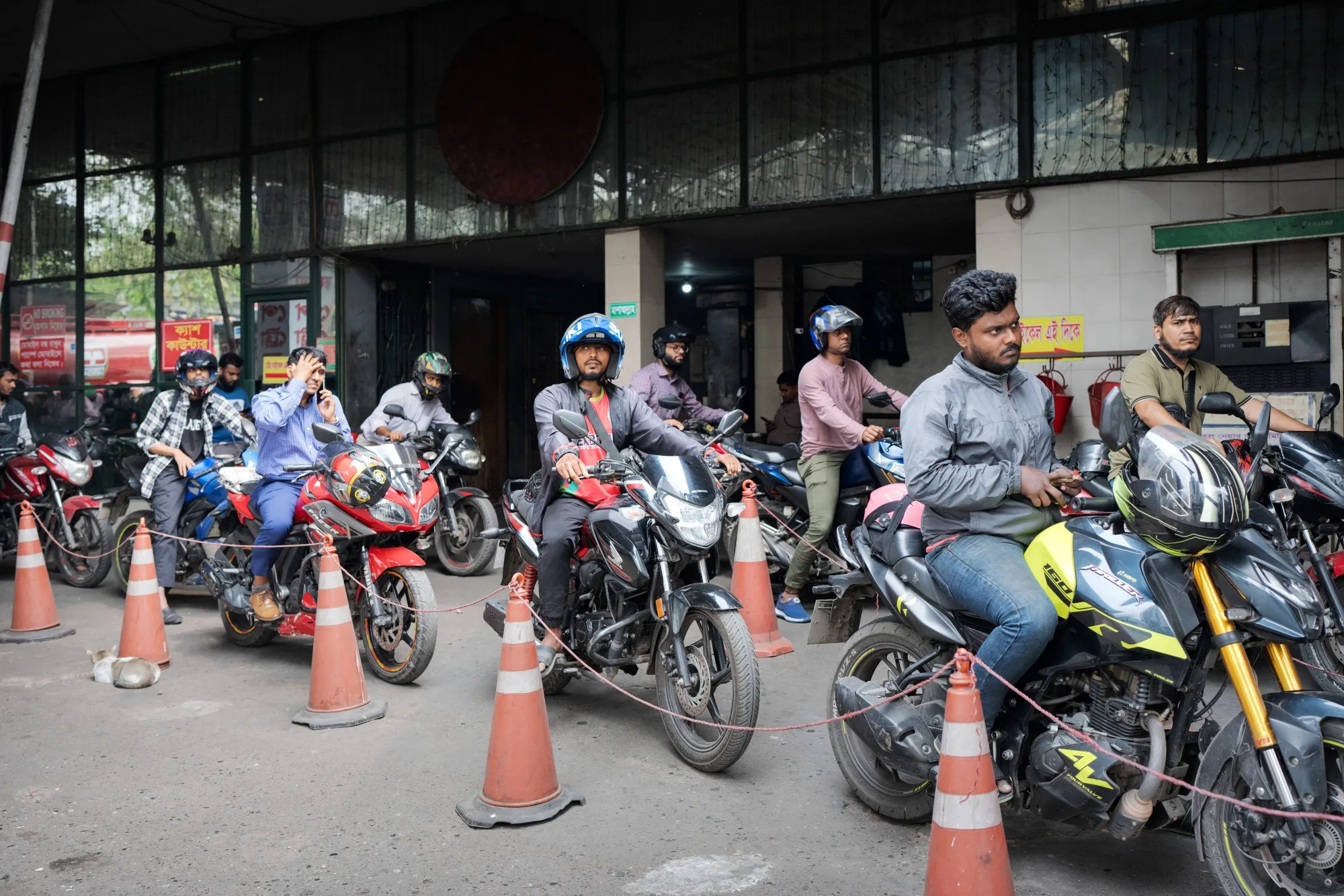 Motorcyclists facing fuel rationing line up outside a filling station in Dhaka, Bangladesh.