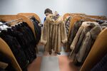 An employee prepares a luxury sable fur coat for display at the Sardaana fur store in Yakutsk, Russia, on Monday, Feb. 15, 2016. Siberian furs are traded around the world.
