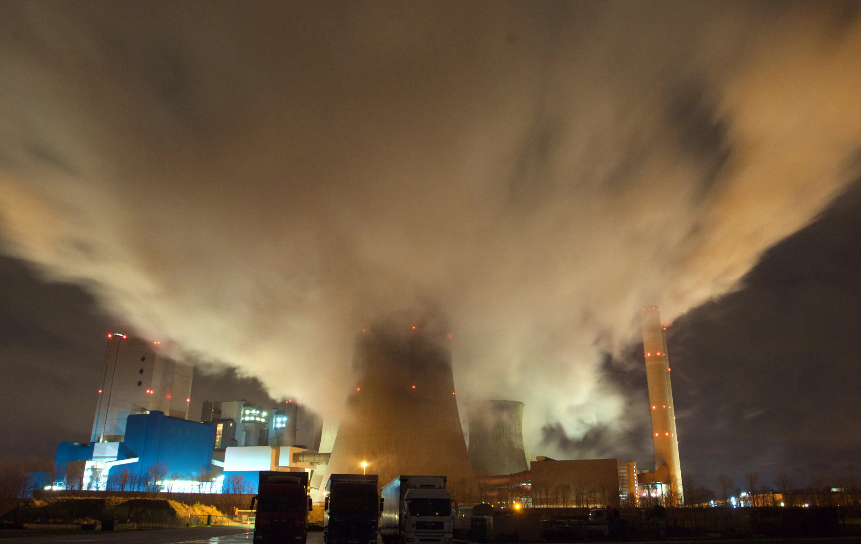 Smokestacks and cooling towers emit smoke near Bergheim, Germany.