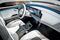 The dashboard features an elongated touchscreen and is free of knobs. The lack of a transmission means the middle console isn’t attached to the dashboard. Electric motors need little cooling, so the Generation EQ’s designers were able to render the trademark Mercedes grille in glass.
