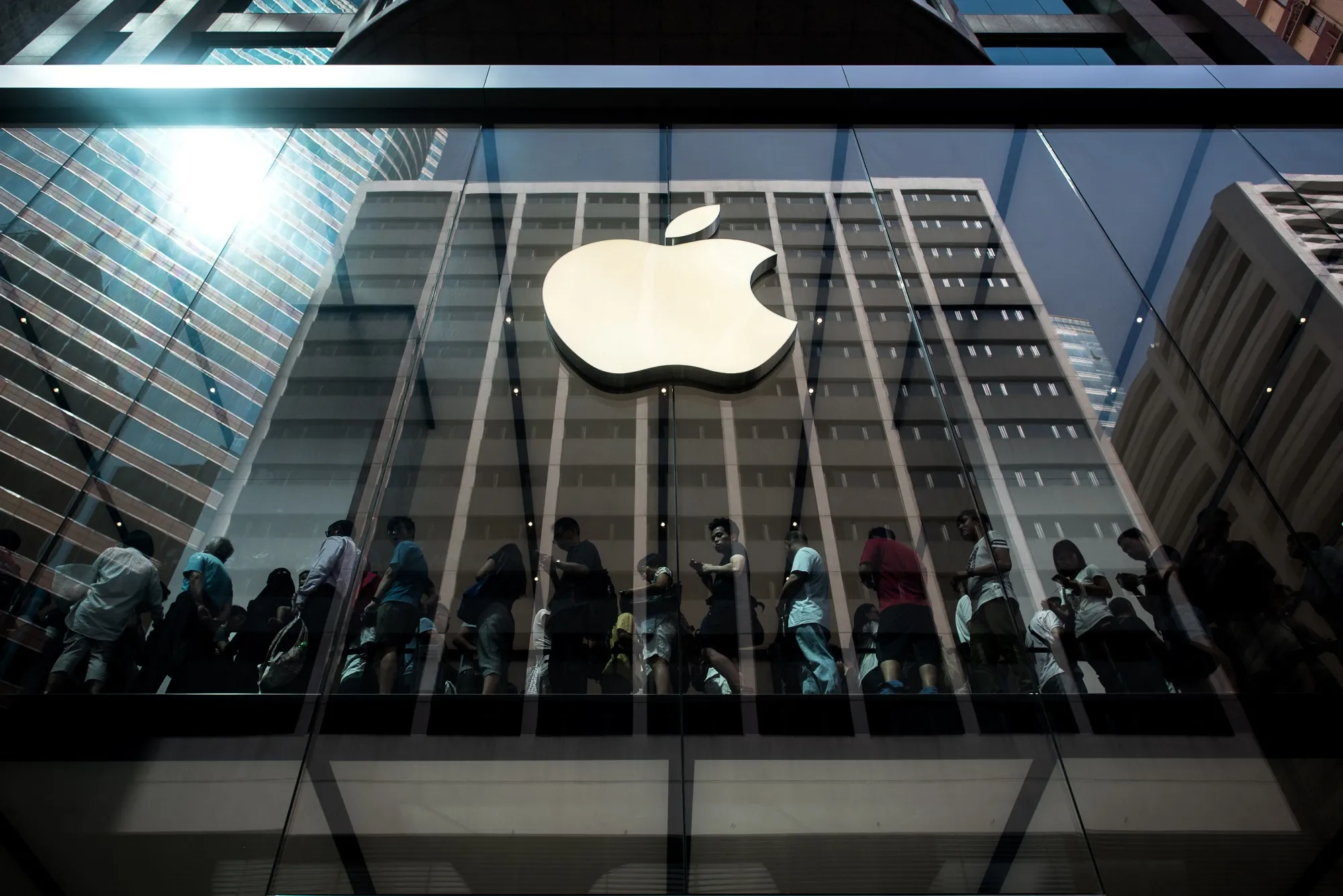 Customers queue inside an Apple store in Hong Kong.