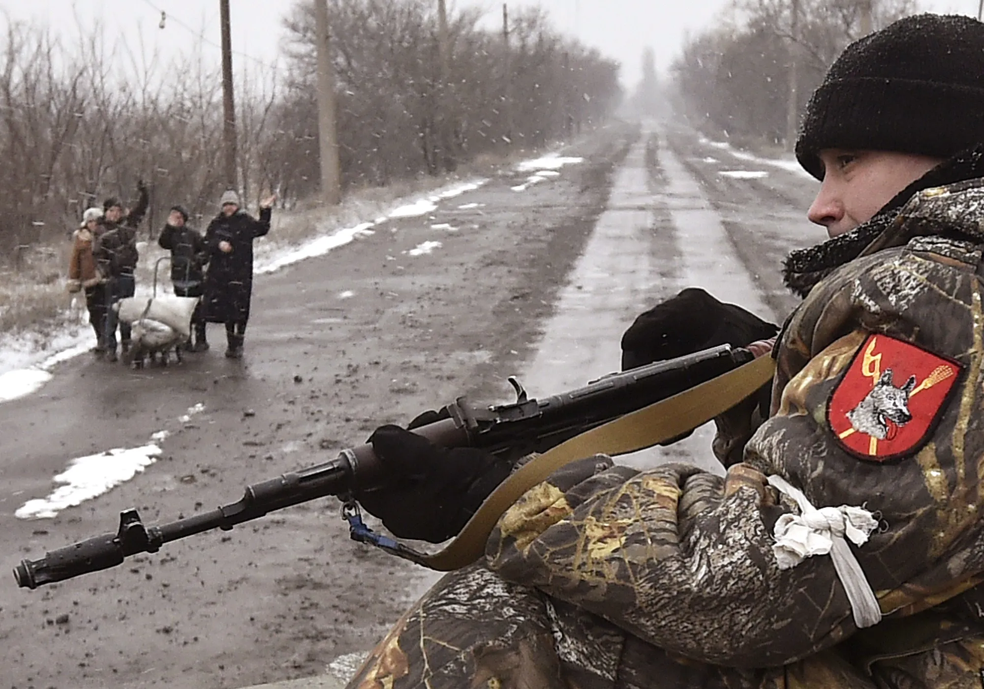 People waves at Pro Russian fighters in Uglegorsk 6 kilometers south west from Debaltseve on Feb. 9, 2015.
