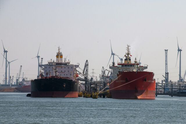 Tankers docked at a terminal near wind turbines at the newly merged Port of Antwerp-Bruges in Antwerp, Belgium, on Thursday, April 28, 2022. 