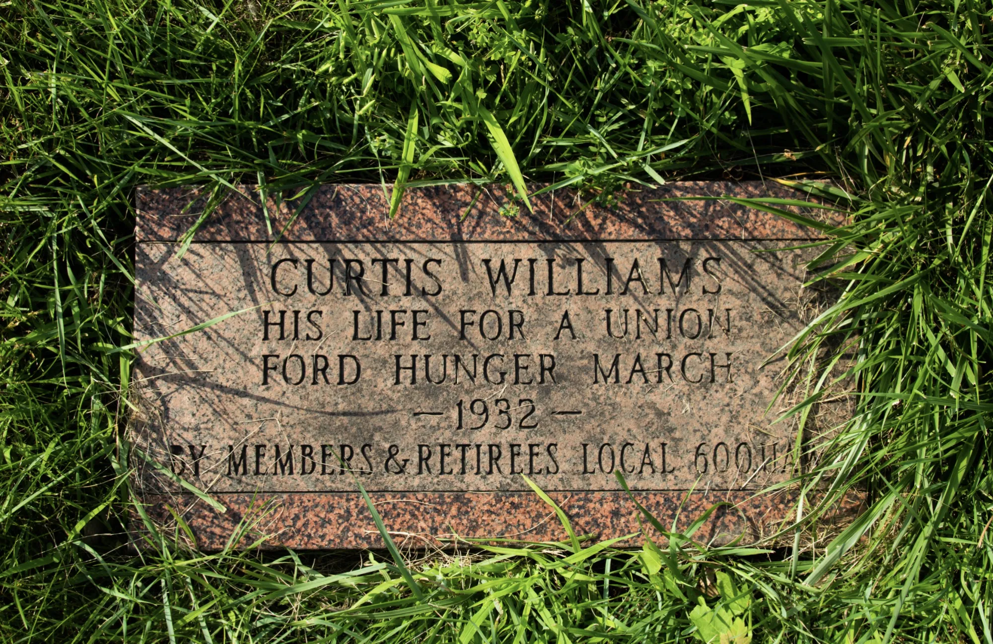 At Detroit’s Woodmere Cemetery, a gravestone reading “His Life for&nbsp;a Union”&nbsp;commemorates Curtis Williams, who was denied burial after the Hunger March because he was Black.