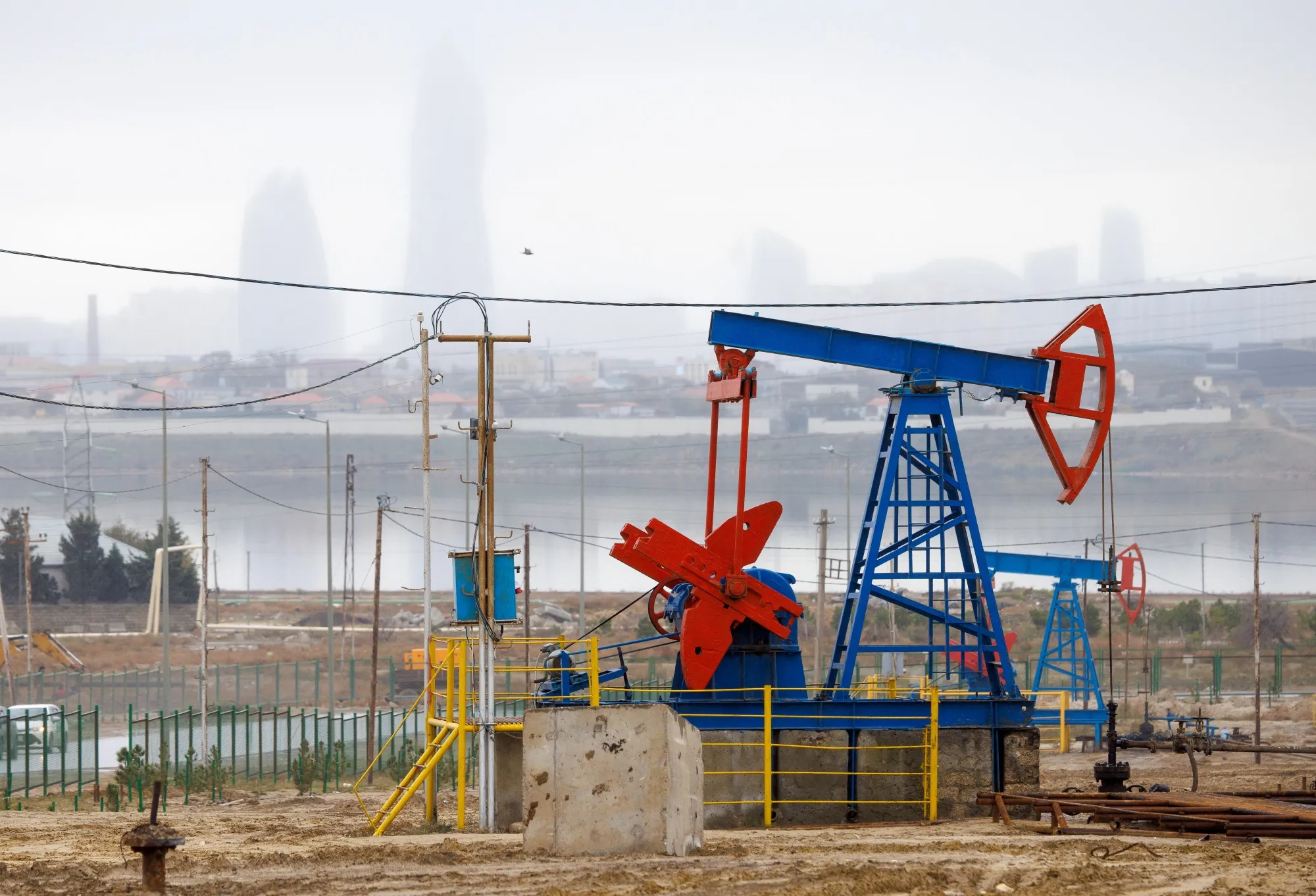 Oil pump jacks and drilling rigs along the Caspian Sea in Baku, Azerbaijan.