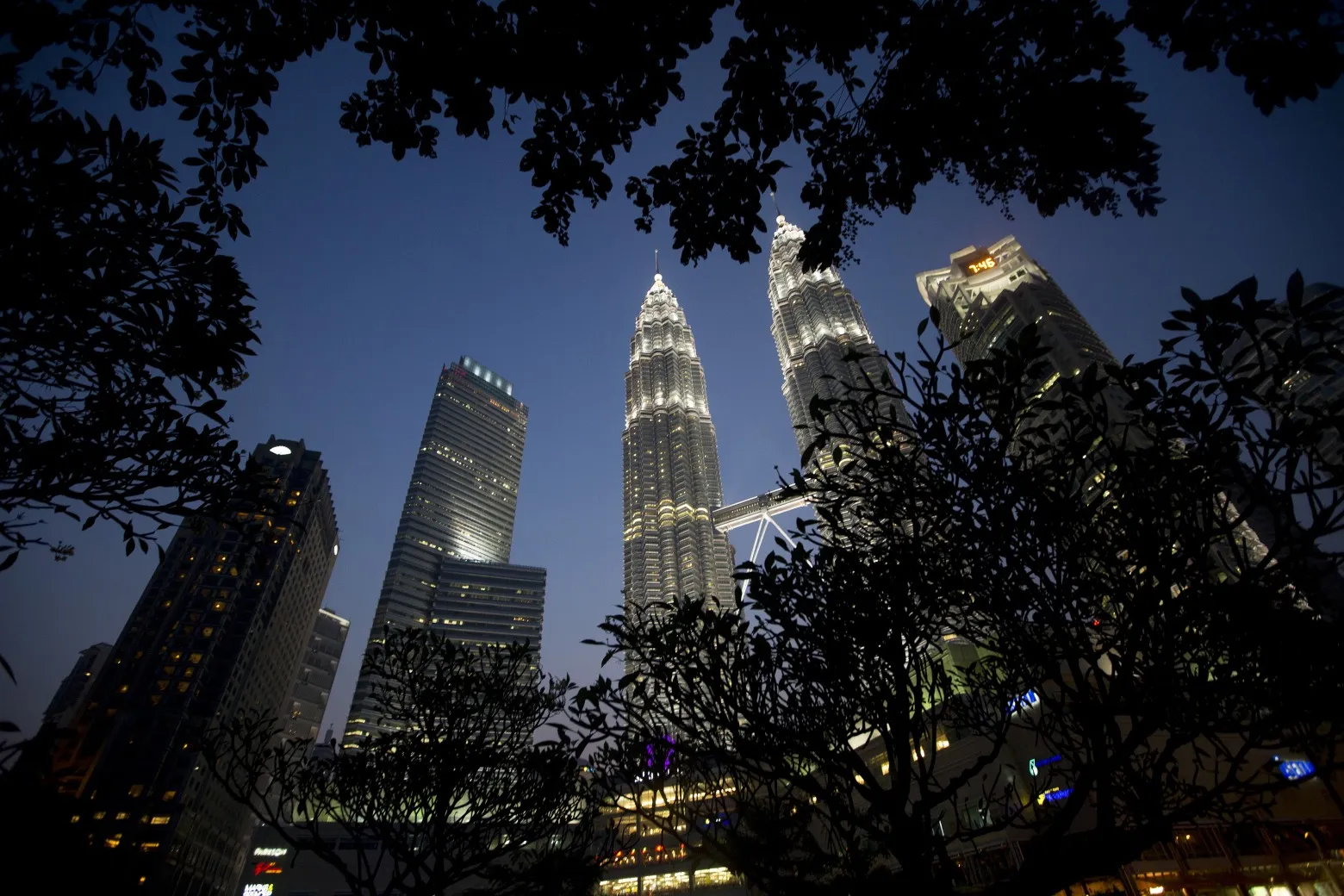 The Petronas Twin Towers stand illuminated at night in Kuala Lumpur, Malaysia, on Monday, July 21, 2014. Malaysian Airline System Bhd. (MAS), reeling from its second disaster in four months, plans to present a revival plan to its state-run parent Khazanah Nasional Bhd. this week, people familiar with the matter said yesterday, amid reports the national carrier is likely near the end of its days as a publicly traded company.