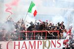 AC Milan players and staff celebrate with the Scudetto Trophy in Milan, on May 23.