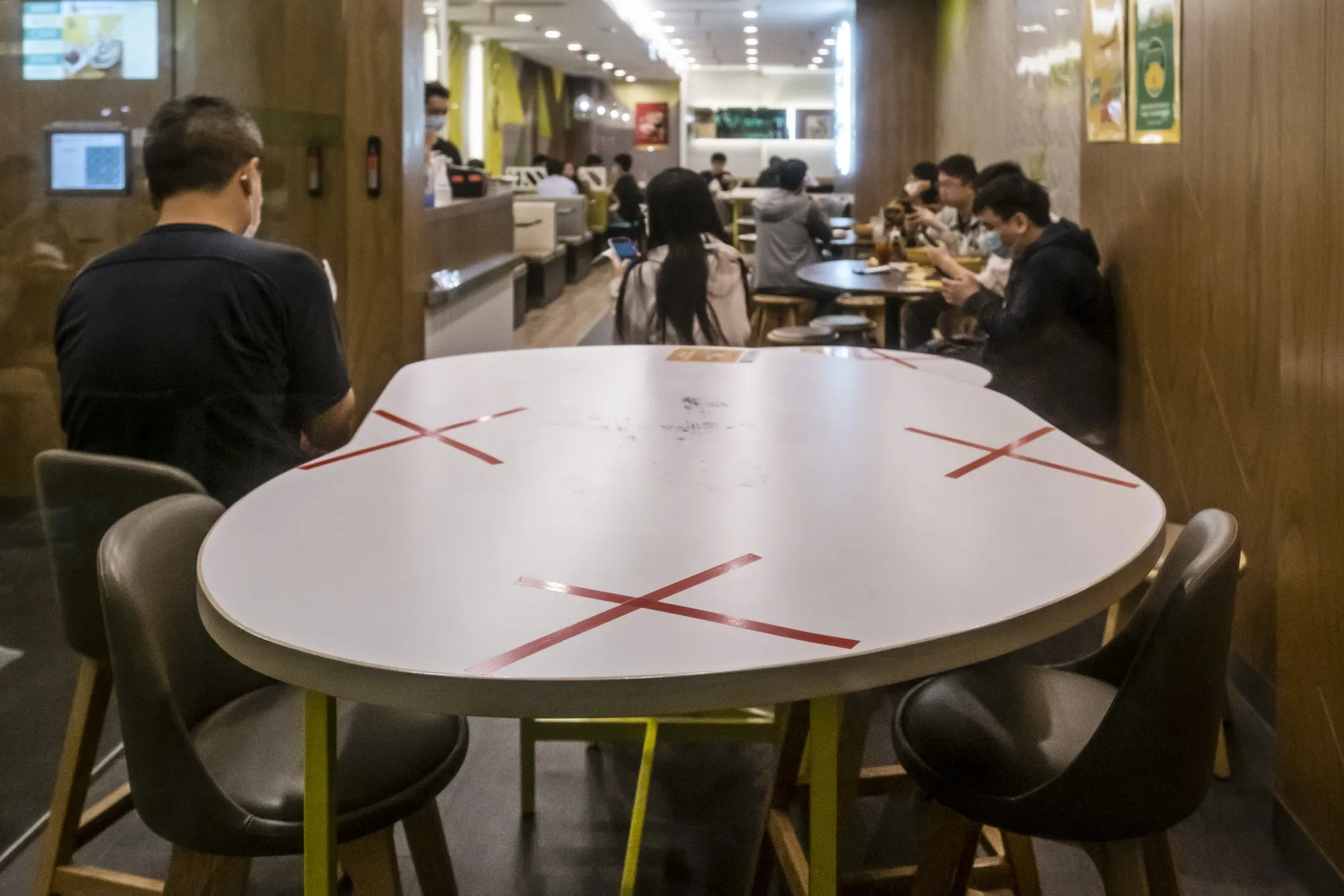 Markings on seats to enforce social distancing measures at a restaurant in Hong Kong, March 28.