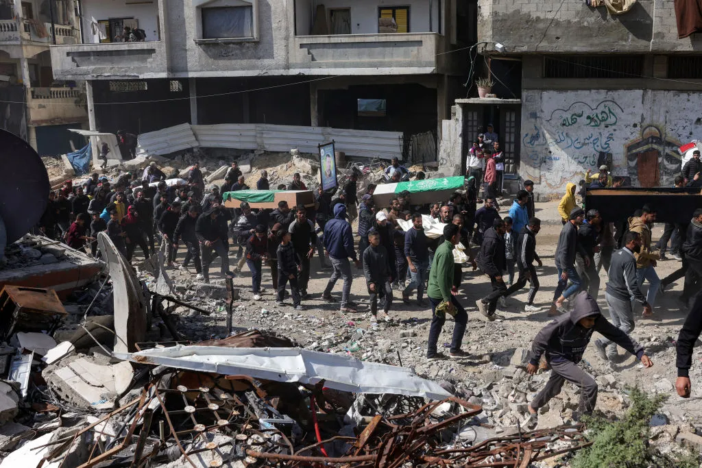 Palestinians and Hamas fighters attend a funeral procession for&nbsp;militants and civilians killed during the war, during the ceazefire, Feb. 28.&nbsp;