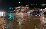 In this photo courtesy of City of Moab, vehicles navigate high waters at the intersection of South Main Street and 100 South in Moab, Utah, Aug. 20, 2022. Jetal Agnihotri, a 29-year-old from Tucson, Ariz., was still missing Monday, Aug. 22, 2022, after being swept away at Utah's Zion National Park three days earlier as flooding surged through the southwestern United States and imperiled tourists visiting the region's scenic parks. (Rani Derasary/City of Moab via AP, File)