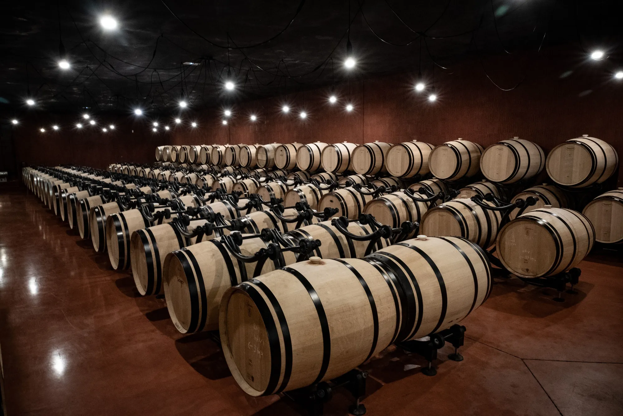 Wine barrels sit in a cellar at a winery in Pomerol, France.