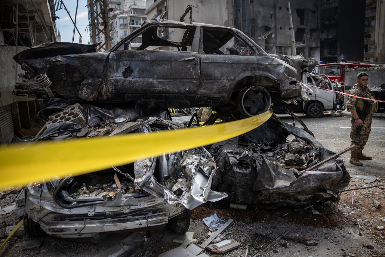 A soldier from the Lebanese army stands next to vehicles destroyed in an airstrike in Beirut on April 9. Photographer: Chris McGrath/Getty Images