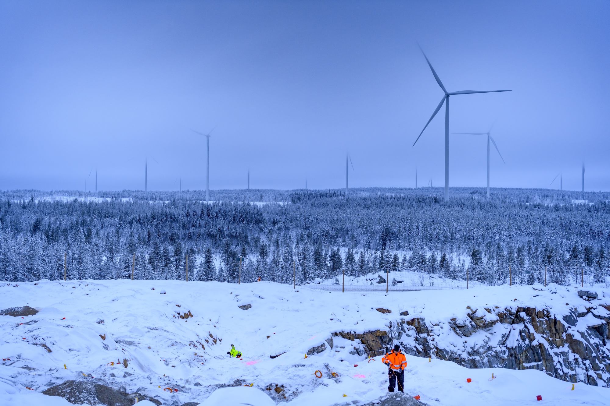 Workers prepare the ground for development work at a wind park project near Pitea, Sweden.