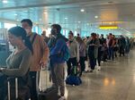 Passengers queue for flights at Heathrow Airport on May 31.