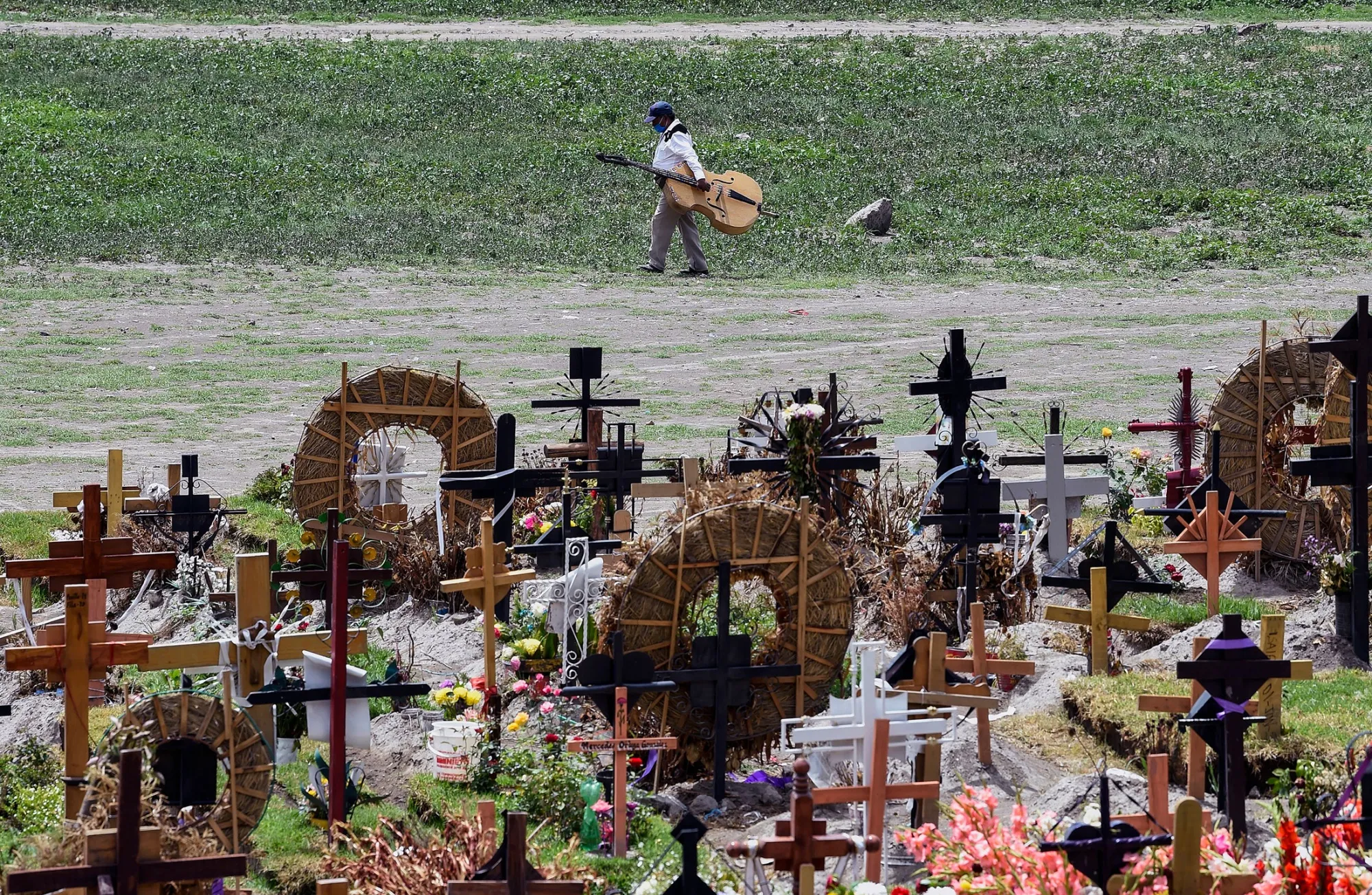 A man walks past graves in the special area of the Municipal Pantheon of Valle de Chalco, State of Mexico, on July 28.