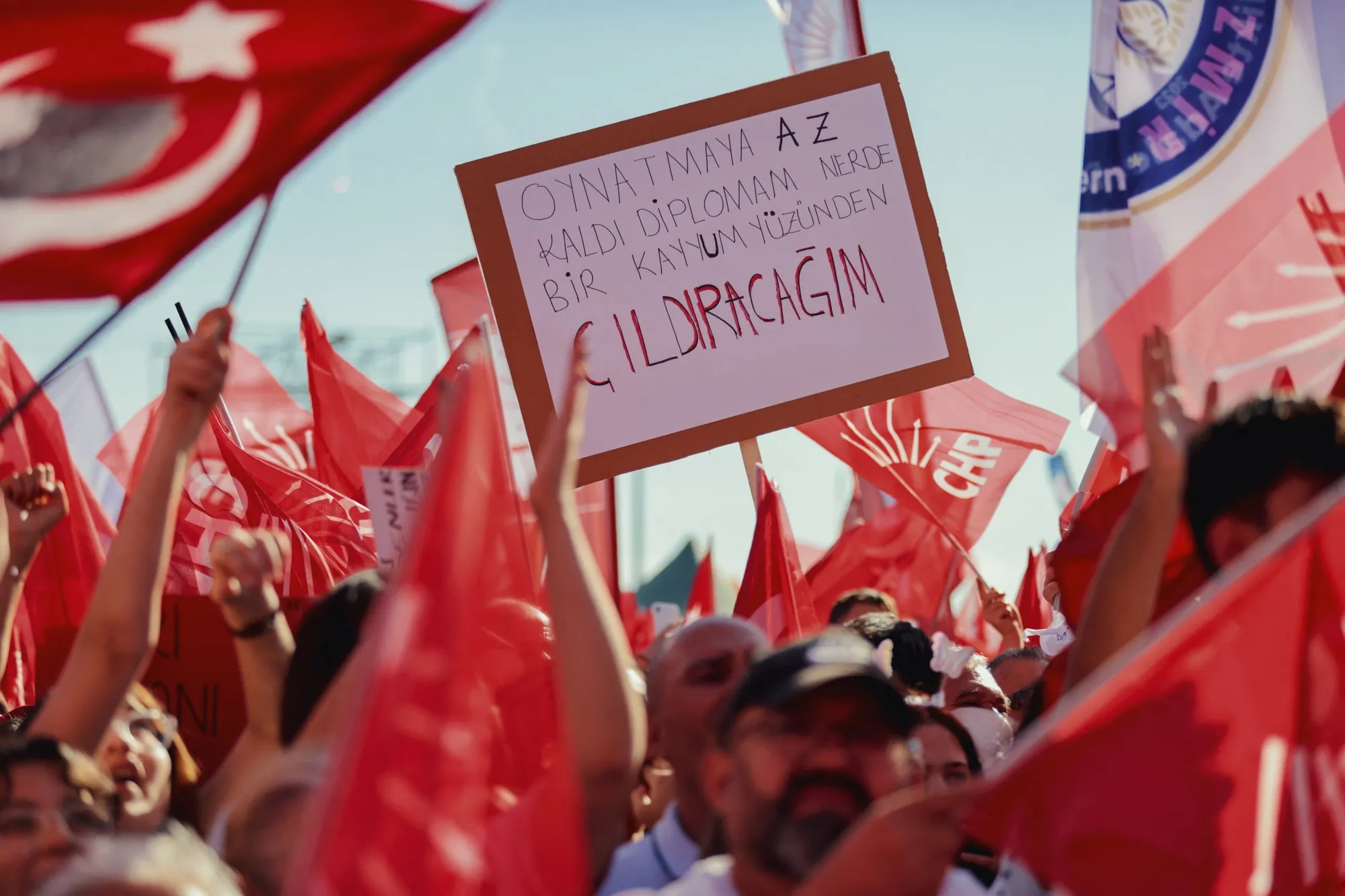 People wave flags and chant slogans during a mass protest rally in support of the arrested Istanbul Mayor Ekrem Imamoglu in Izmir, Turkey, on May 19.&nbsp;