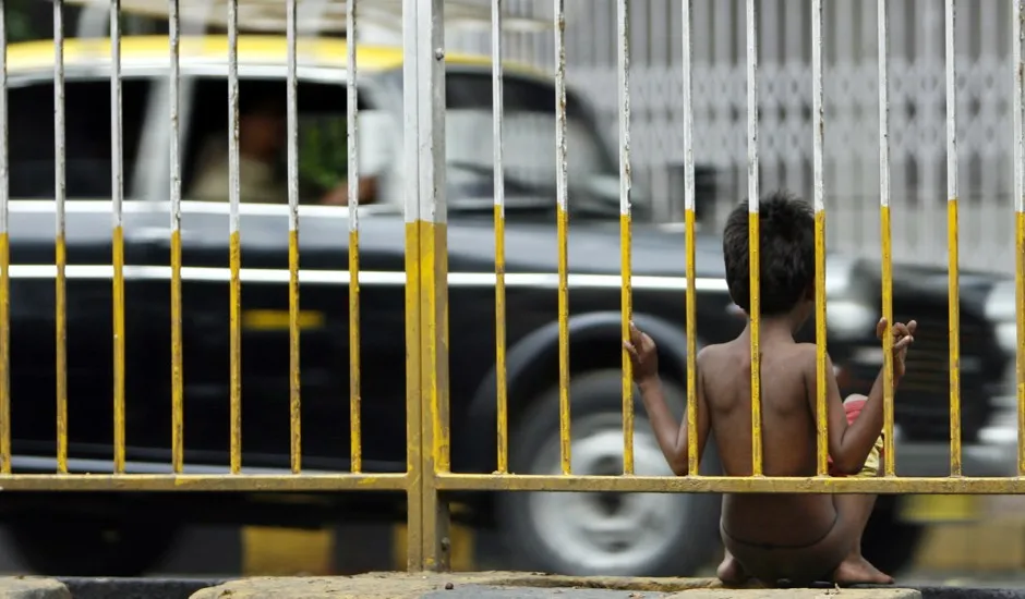 A boy sits in a Mumbai slum; South Asia is one of the regions still struggling with extreme poverty.