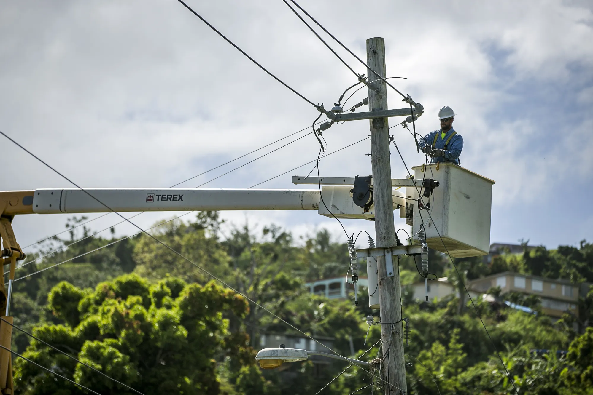 A worker fixes power lines&nbsp;in the town of Limones, Yabucoa, Puerto Rico, on&nbsp;May 18, 2018.&nbsp;