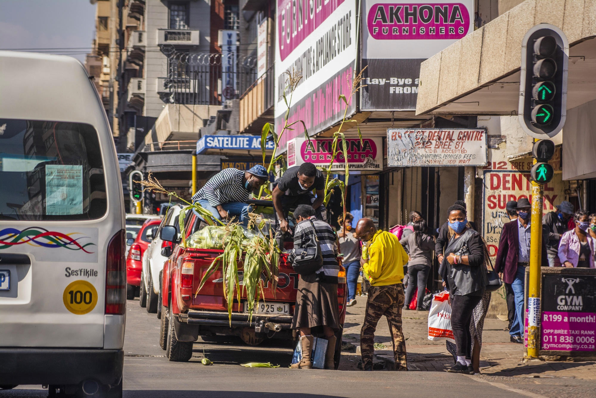 People gather to buy corn from a street vendor in Johannesburg.