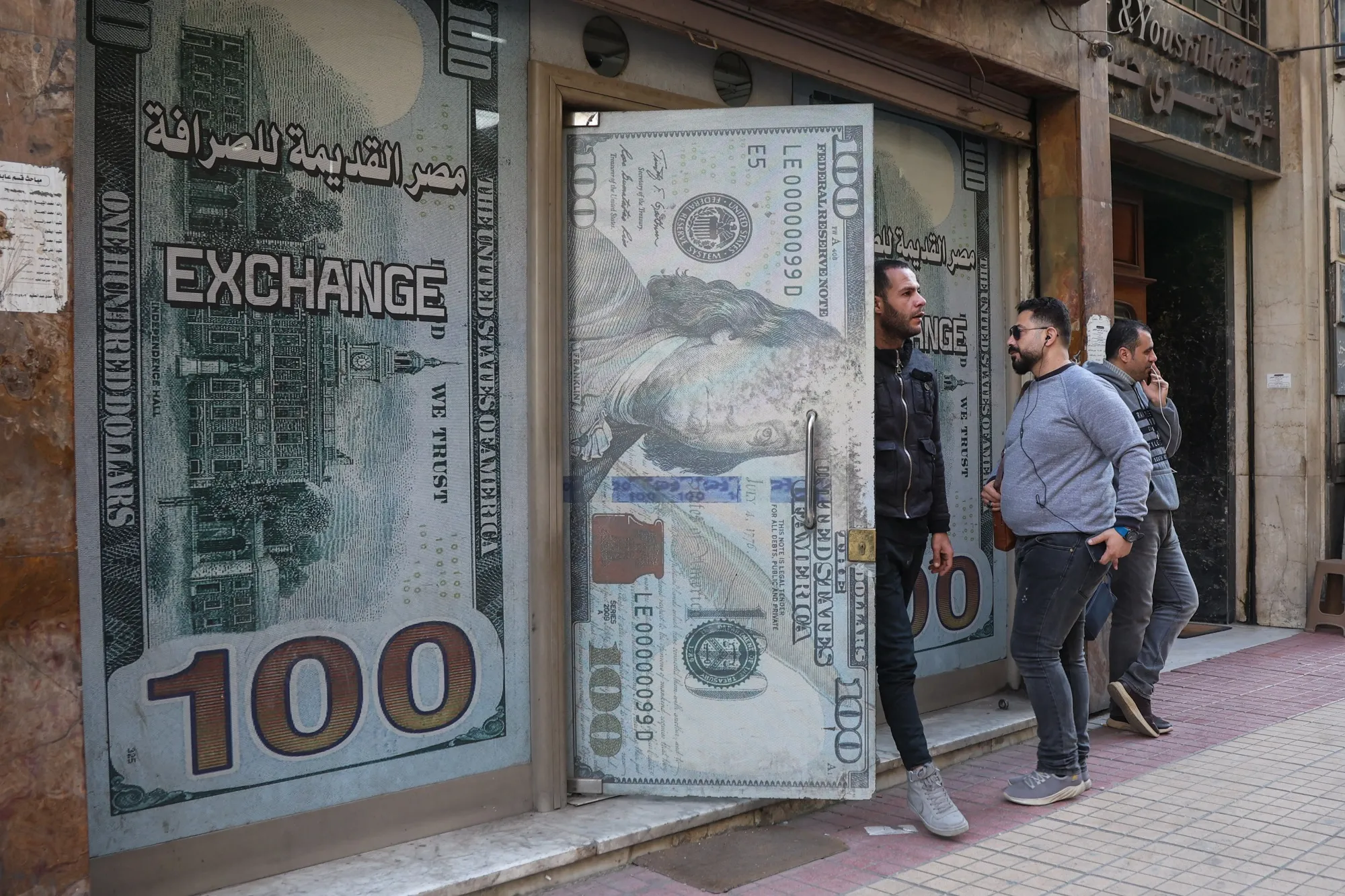Visitors outside a foreign currency exchange bureau in Cairo, Egypt.
