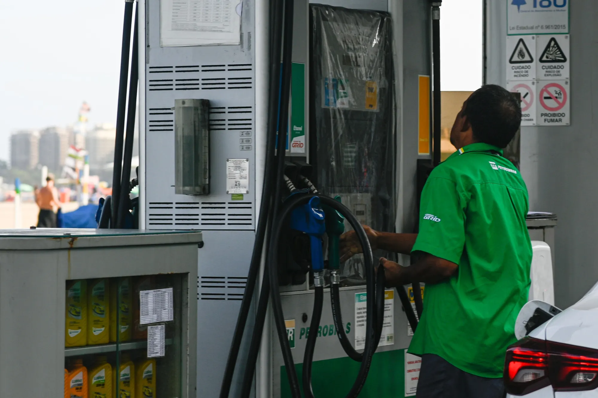 A worker prepares to refuel a vehicle at a Petrobras gas station in Rio de Janeiro on April 8, 2022.