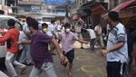 Police officers disperse a crowd flouting social distance outside a government liquor shop in New Delhi on May 4.