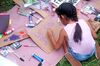 A child paints a sign during a protest rally outside the Homestead Temporary Shelter for Unaccompanied Children, in Florida. 