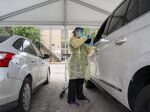 A healthcare worker administers a Covid-19 test at the Austin Regional Clinic drive-thru vaccination and testing site in Austin, Texas, U.S., on Thursday, Aug. 5, 2021. In a virtual briefing Wednesday, the Texas Department of State Health Services said hospitalizations and cases are rising in the state in unvaccinated people, largely because of the delta variant, reports NBC-affiliate KXAN.