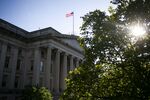 An American flag flies above the U.S. Treasury building in Washington, D.C.