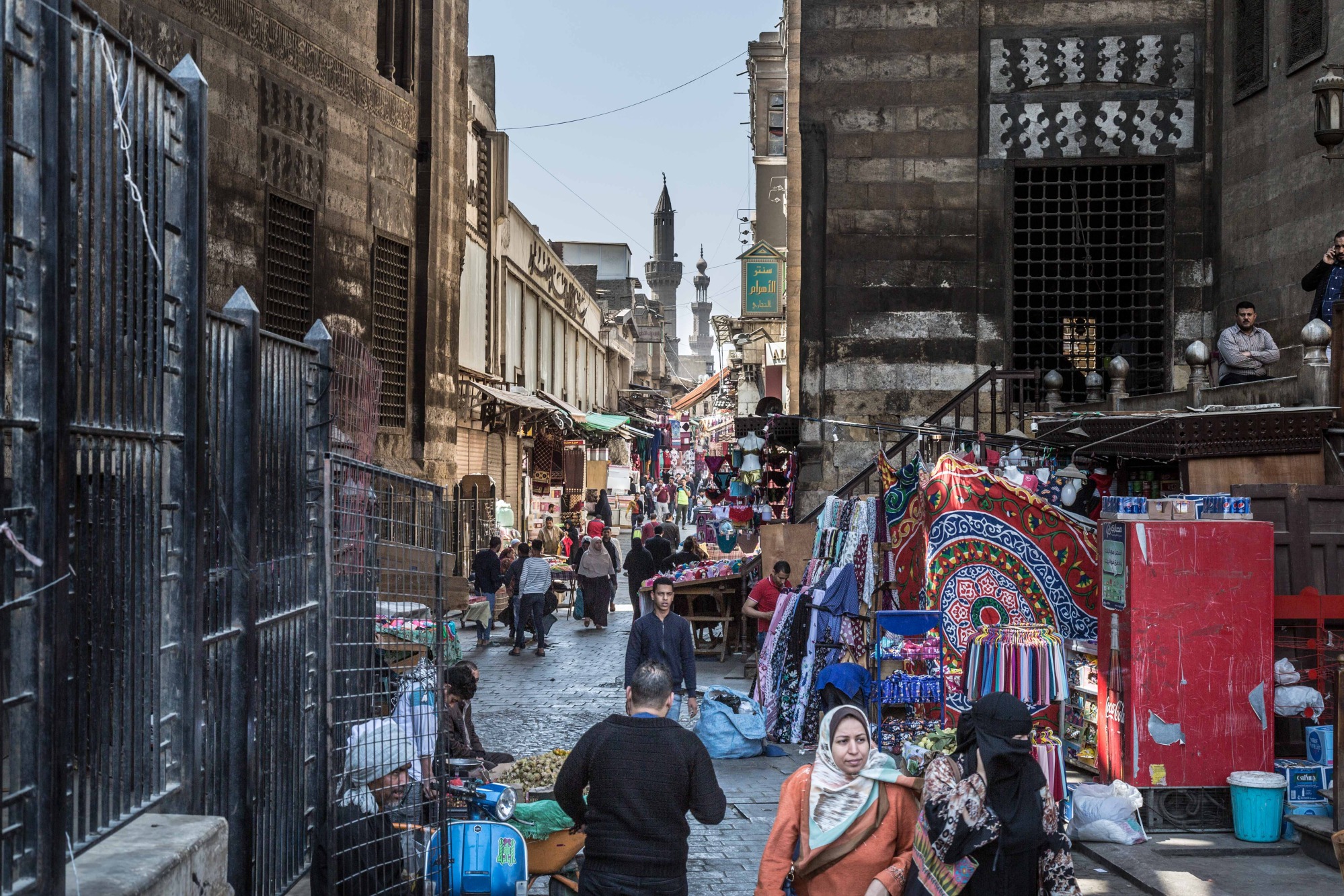 Pedestrians pass among market stalls in Cairo.