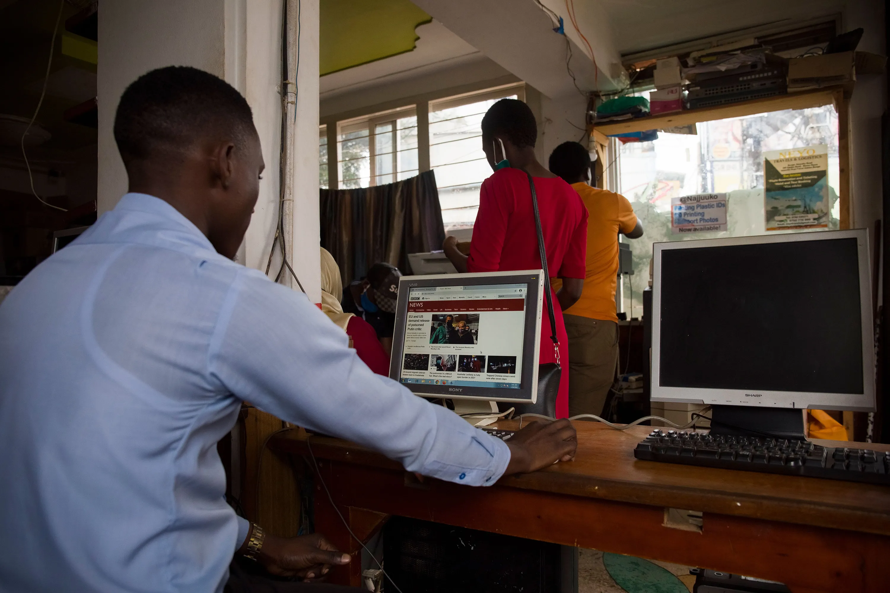 A man uses a computer to read news at a cyber cafe&nbsp;in Kampala, Uganda.