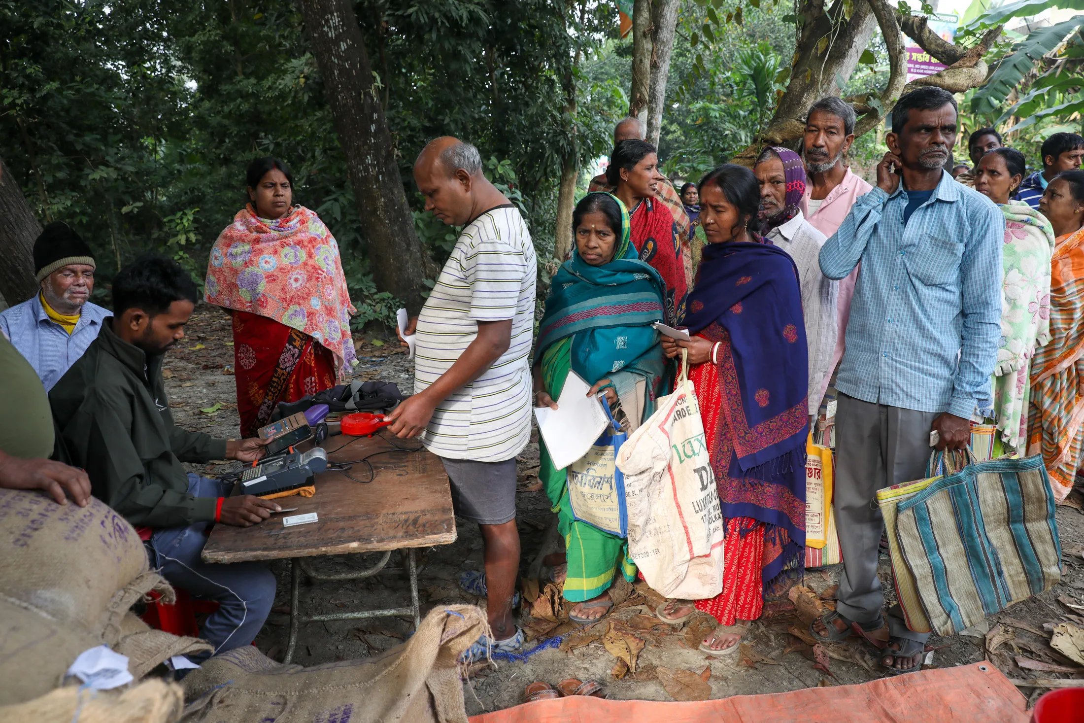 People line up to receive rations&nbsp;in a village on the outskirts of Kolkata.