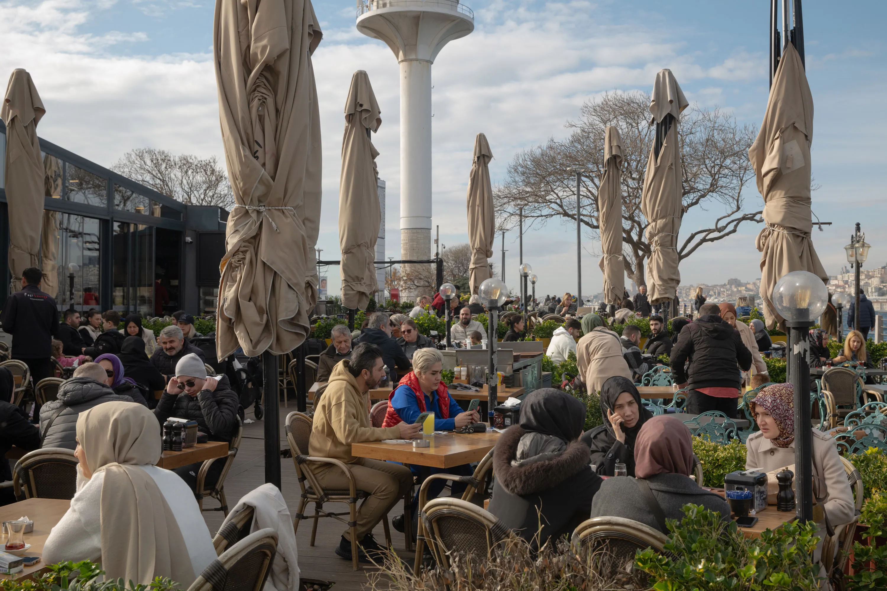 Customers dine at a cafe terrace area in the Uskudar district in Istanbul.