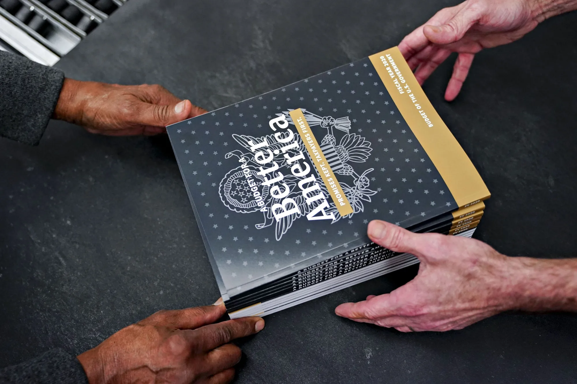 Employees arrange copies of the fiscal year 2020 budget inside the Government Publishing Office (GPO) production facility in Washington, D.C.