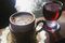 Close-Up Of Coffee In Cup With Red Wine On Railing