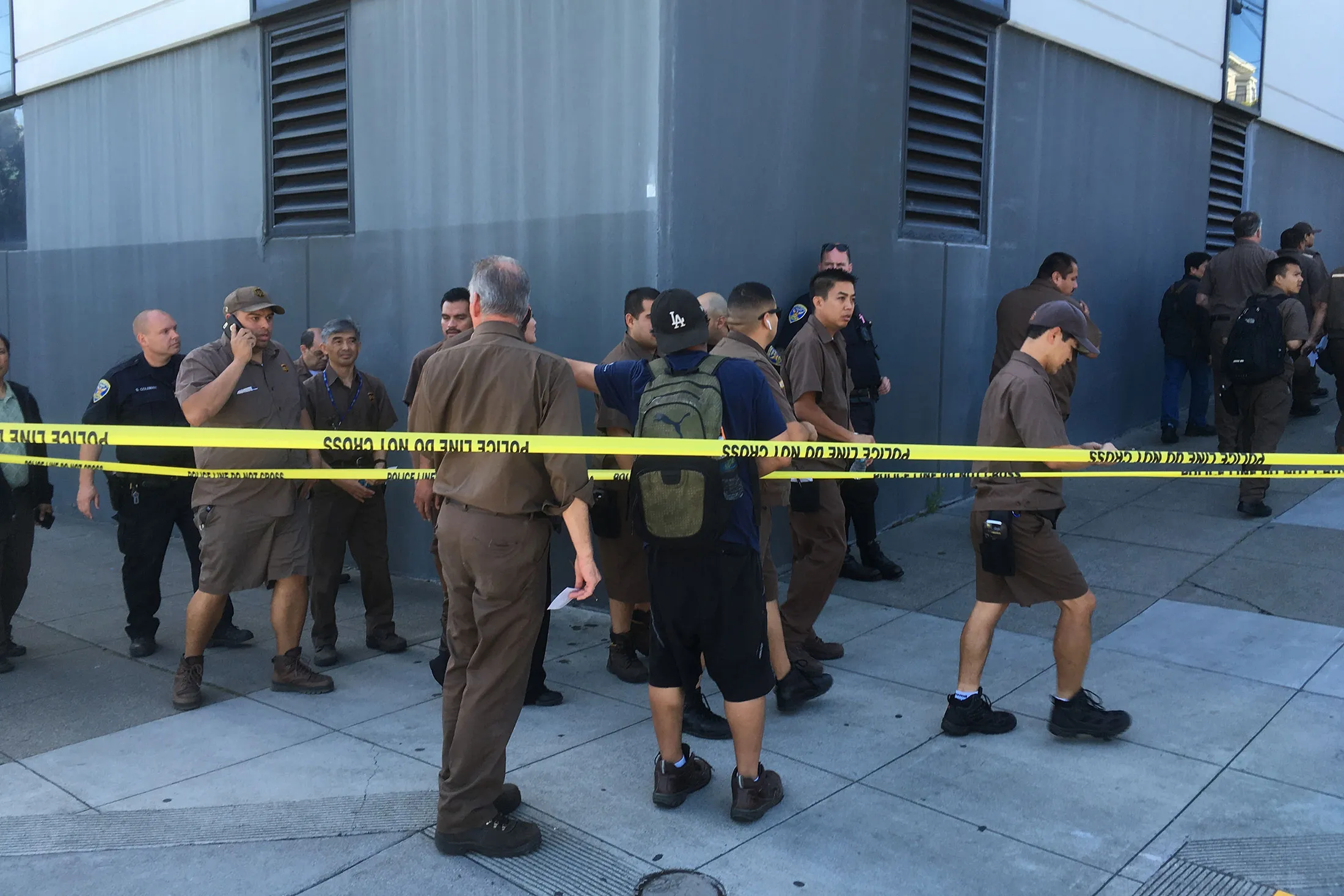UPS workers gather outside after a reported shooting at a UPS warehouse and customer service center in San Francisco on Wednesday, June 14, 2017.
