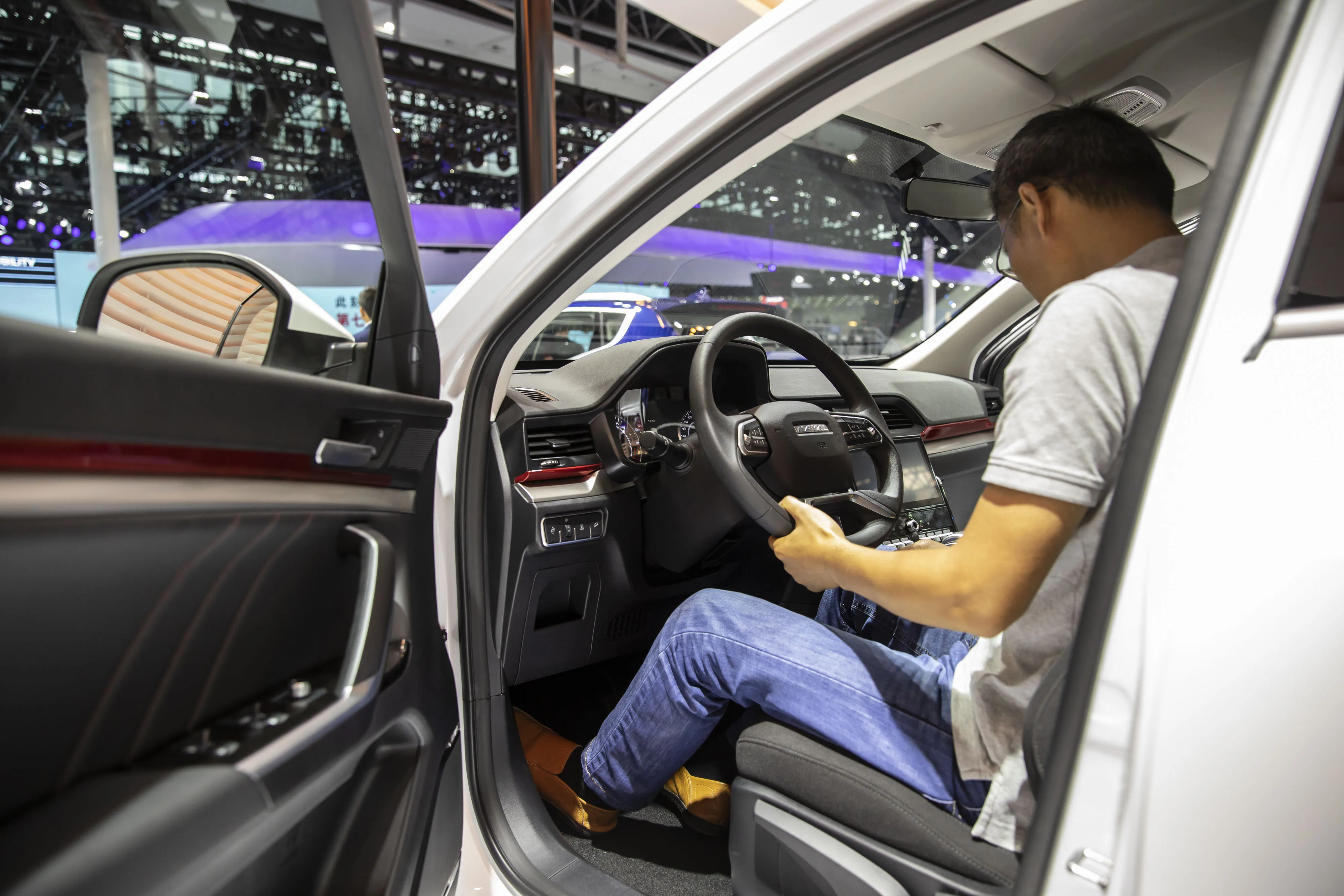 An attendee sits inside a Great Wall Motor&nbsp;Haval H4 SUV.