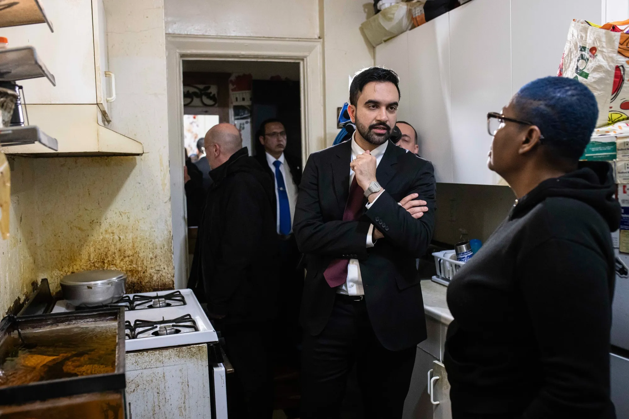 Zohran Mamdani speaks with a resident while visiting an apartment building in the Brooklyn borough of New York following his inauguration on Jan. 1.