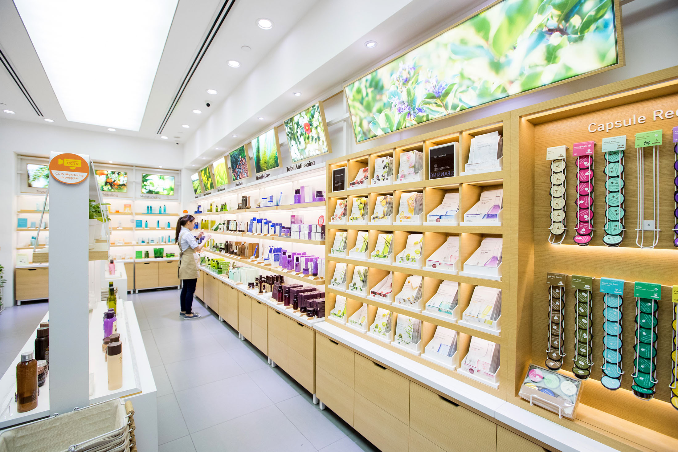 A employee organizes products in the store of Innisfree, an Amorepacific Corp. cosmetic brand, at the Ngee Ann City shopping and commercial center in Singapore, on Tuesday, Sept. 12, 2017.
