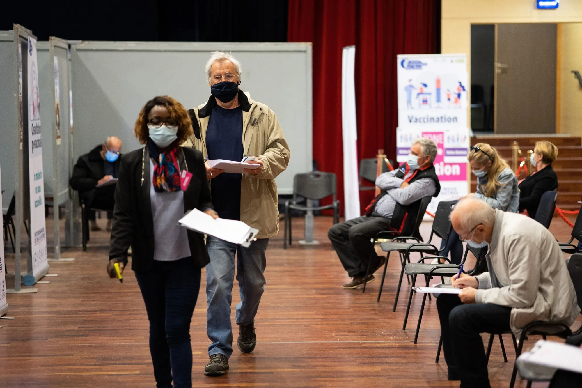 People wait at&nbsp;a Covid-19 vaccination center in Sainte-Genevieve-des-Bois, in France.