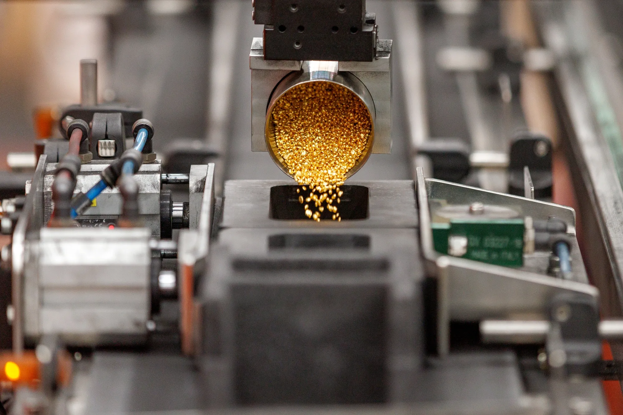 Gold granules are poured into molds for gold bars.