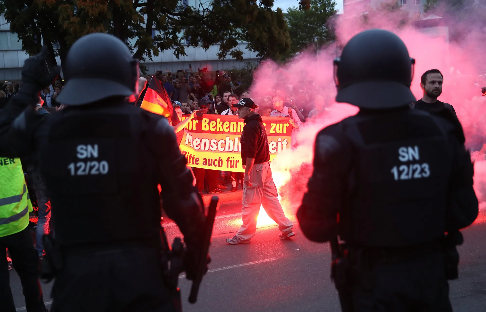 Riot police watch right-wing demonstrators in Chemnitz on Aug. 27.&nbsp;