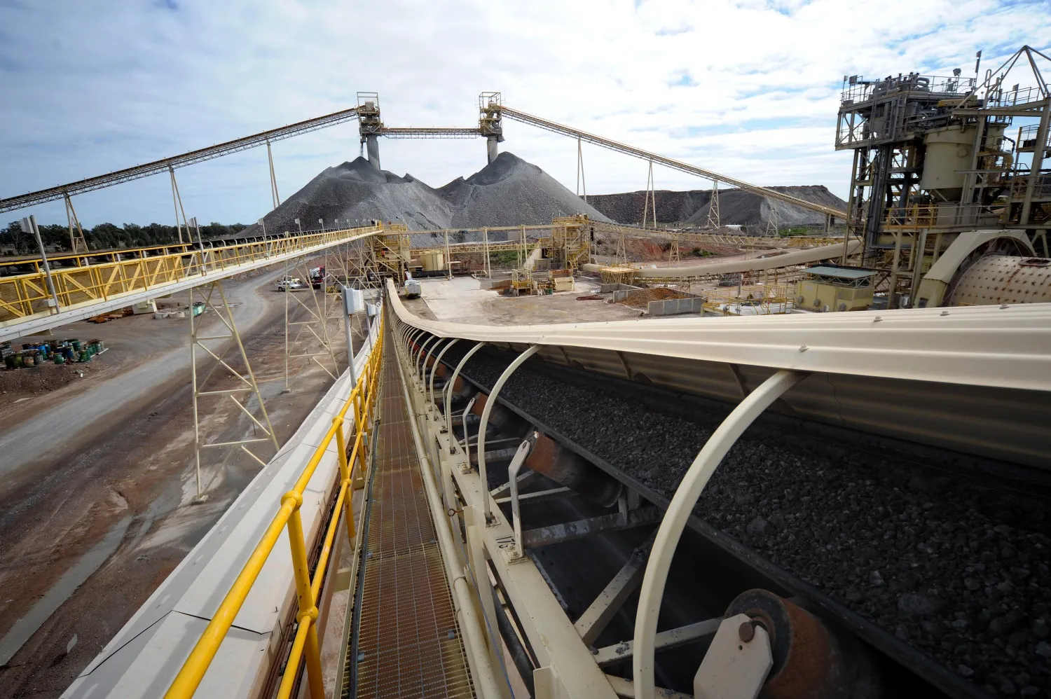 Copper ore moves along a conveyor belt from a stockpile at a Rio Tinto processing plant.