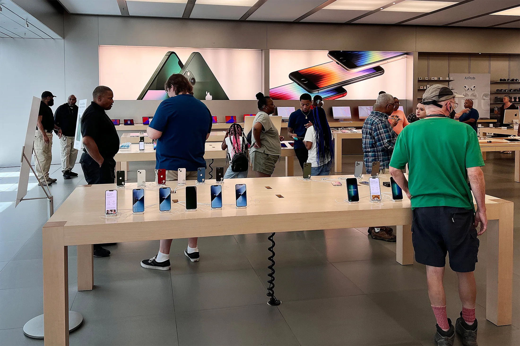 Customers shop at the Apple Store at the Towson Town Center mall in Towson, Maryland, on June 20, 2022.