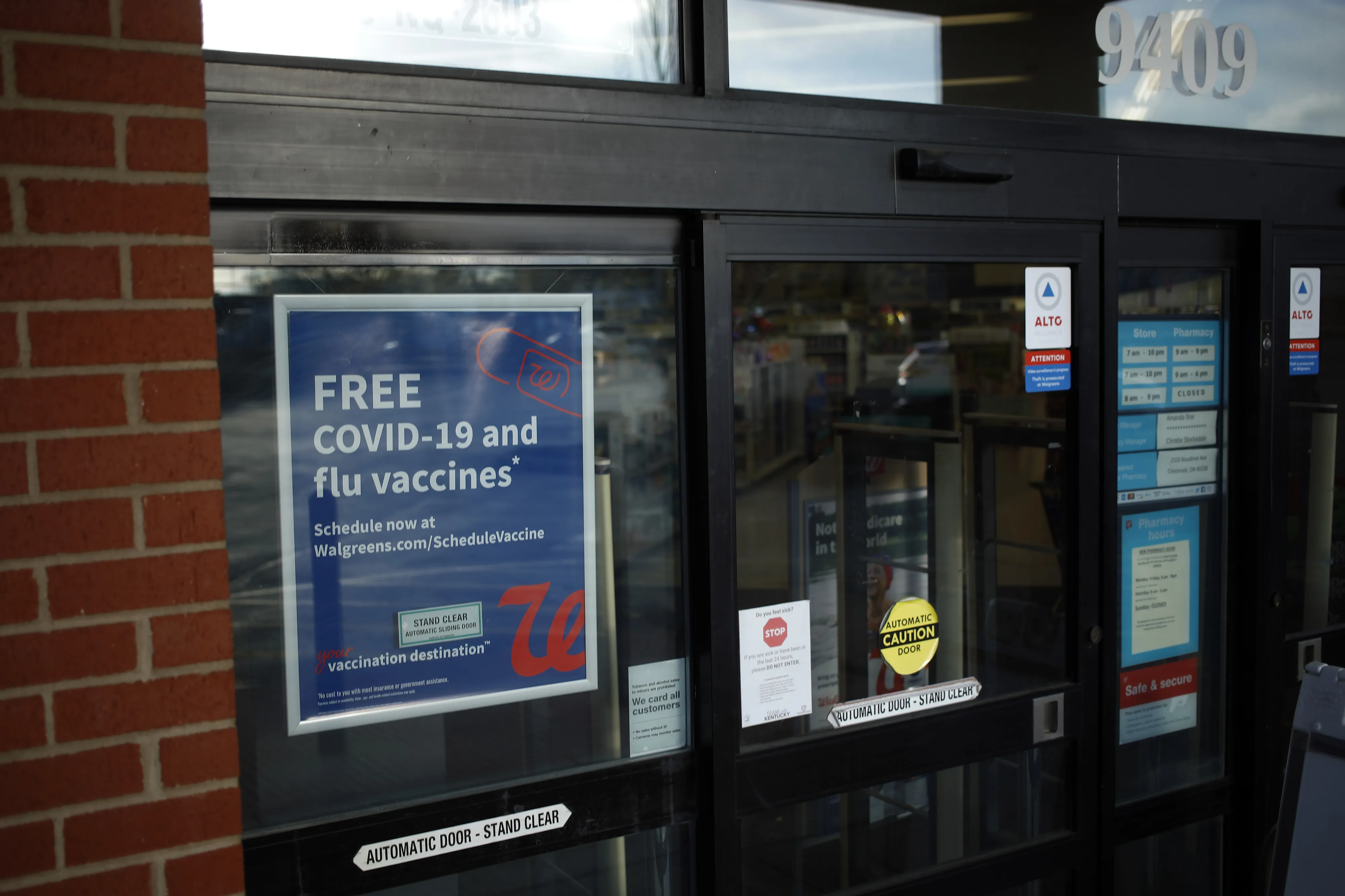 A sign offers customers free Covid-19 and flu vaccines at a Walgreens location in Louisville, Kentucky, U.S., on Thursday, March 24, 2022.
