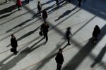 People cast shadows as they walk through the Seoul Station in Seoul, South Korea, on Monday, Jan. 13, 2014.
