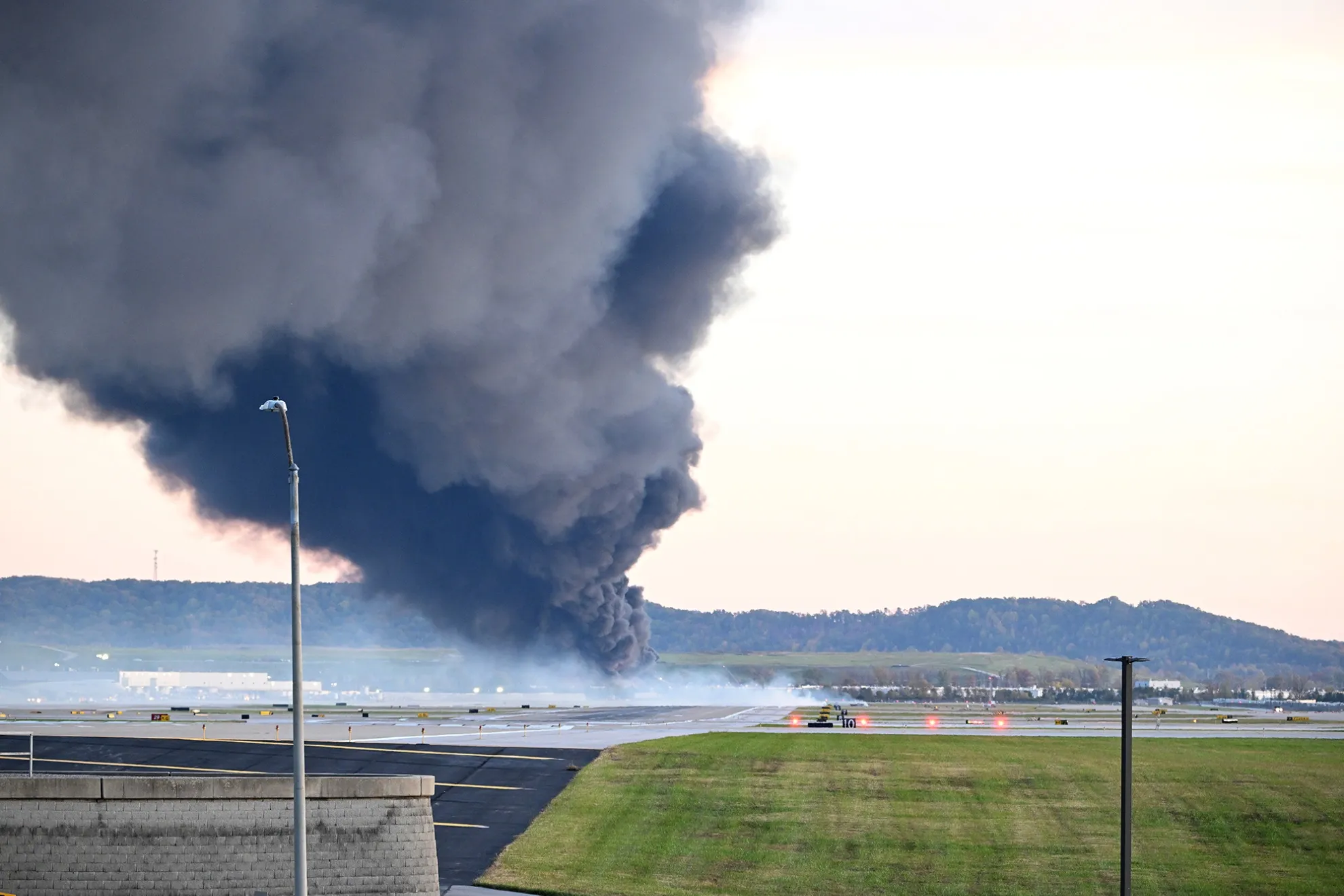 Fire and smoke mark where a UPS cargo plane crashed near Louisville Muhammad Ali International Airport in Louisville, Kentucky, on Nov. 4.