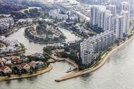 The Seascape, foreground right, and other luxury property developments at Sentosa Cove stand on Sentosa Island in this aerial photograph taken above Singapore, on Thursday, July 2, 2015. Singapore's economy contracted more than analysts predicted last quarter, underscoring the weakening outlook for Asian nations amid sluggish global growth. The local dollar weakened to its lowest level in more than a month. Photographer: Darren Soh/Bloomberg