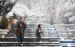 An Iranian woman and child after snowfall in the capital Tehran on Dec. 24, 2022.